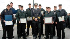 Members of the Marine System Engineering department on board HMCS Winnipeg hold their career advancing qualifications certificates received from Cdr Jeffrey Hutchinson, the ship’s Commanding Officer in the centre.
