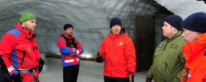Members from 103 Squadron Gander, NL exchange experiences with members from the Iceland Association for Search and Rescue (ICE-SAR) inside Langjokull glacier during a Joint SAR Exercise held in Iceland on February 10, 2016. Standing Left to Right: August Thor, a member from ICE-SAR, Sergeant (Sgt) Sean Daniell, Corporal Ryan Dyer, Master Warrant Officer Mike Hurtubise and Sgt Kevin O'Donnell.
