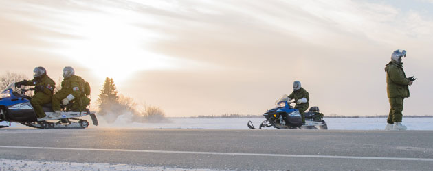 soldiers on snowmobiles