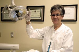 Dental Hygienist Reine RIcher Laflech prepares for a patient at the Dockyard Dental Clinic, a few weeks before she retired.