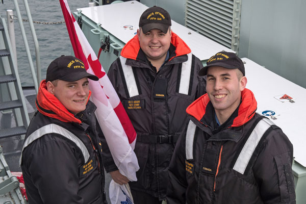 sailors smile as ship leaves harbour