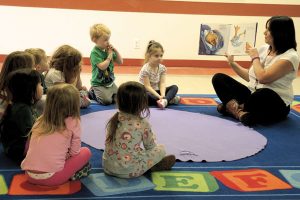 Above: Leanne Harel, MFRC Childcare Supervisor, reads aloud a children’s book to a group of five to eight year olds in accordance with Mary Gordon’s Seeds and Roots of Empathy philosophy.