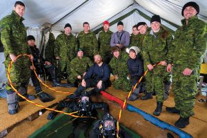 Photos by PO2 Bibeau, FDU(P) The Operational Dive Team poses for a picture during the ice dive exercise on Lac Des Roches in Lone Butte, B.C.