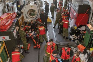 Cpl Stuart MacNeil, MARPAC Imaging Services On board HMCS Ottawa, a simulated causality receives medical care from a team of doctors, physician assistants, nurses and medics from Canadian Forces Health Services Centre (Pacific) during SMASHEX 2016.