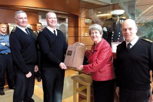 LS Calvin Langager (second from left) accepts the Sailor of the Year plaque from Geraldine Hinton while Cmdre Zwick (left), Commander Canadian Fleet Pacific, and CPO1 Michel Vigneault offer their congratulations.