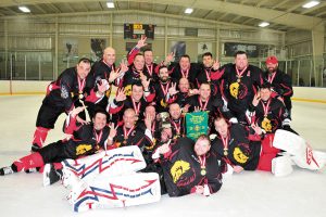 Peter Mallett, Lookout Valcartier players celebrate and gather for a team shot after capturing the CAF Old Timers Hockey Championship at Wurtele Arena, March 10. Valcartier defeated Petawawa 5-1 to claim their third consecutive national title.