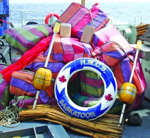 Photos Op Caribbe A crewmember from HMCS Saskatoon and members of the United States Coast Guard Law Enforcement Detachment secure the seized cocaine bales.