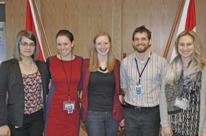 Former co-op student Katelyn Moores (centre) poses with current co-op students (from left to right) Sonya Chwyl, Lindsey Hardcastle, Cameron Carswell and Amanda Lichon, to celebrate Moores recent acceptance of a full-time position with Maritime Forces Pacific Public Affairs.