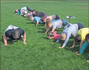 LS Andrée Noye encourages students to do push ups as part of the LEAD program.