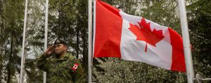 Cpl Étienne Brassard, member of the 1st Battalion, Royal 22e Régiment salutes the Canadian flag at the closing ceremony of Exercise SCORPION FURY in Cincu, Romania on April 20. Photo: Corporal Guillaume Gagnon