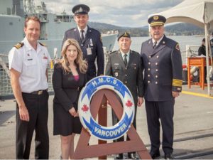 From left to right: Cdr Clive Butler, Vancouver City Counsellor Melissa De Genova, Constable Blair Da Costa, HLCol Allen De Genova, and Fire Chief Tim Armstrong pose for a photo before departing the ship.