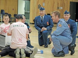 Robert “Scratch” Mitchell, a retired Lieutenant-Colonel who served for 20 years in Canada’s Air Force, looks on during a first aid demonstration by the 848 Royal Roads Royal Canadian Air Cadet Squadron during their 39th annual Ceremonial Review at Belmont Secondary School in Langford. Bottom left: Mitchell inspects members of the Squadron.