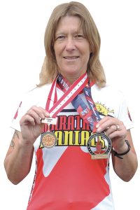 Tracy Voorthuyzen, winner of the Senior Women’s Gold Medal for the Canadian Armed Forces Running Nationals marathon in Ottawa, poses with her medals.