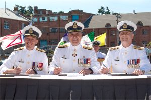 From the left: Rear-Admiral Gilles Couturier, Vice-Admiral Ron Lloyd, and Rear-Admiral Art McDonald sign Change of Command Certificates. Photo by Leading Seaman David Gariépy 