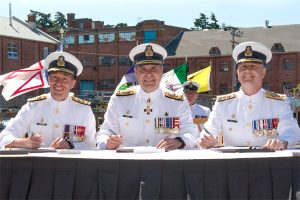 From the left: Rear-Admiral Gilles Couturier, Vice-Admiral Ron Lloyd, and Rear-Admiral Art McDonald sign Change of Command Certificates. Photo by Leading Seaman David Gariépy