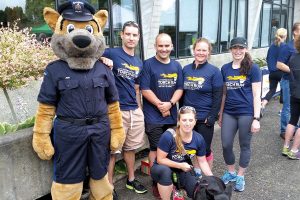 From left to right, SLt Leblanc, MCpl Edwards and PO2 Nilsson from MPU Esquimalt; Lt(N) Joiner; and Capt Harris of Canadian Forces National Investigation Service Pacific Region participate in the Victoria Law Enforcement Torch Run.