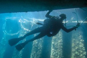 A Caribbean diver conducts a hull inspection as part of a counter-mine training scenario during Exercise Tradewinds 16 in Montego Bay, Jamaica on June 20.  Photo by Sgt Yannick Bédard, CF Combat Camera