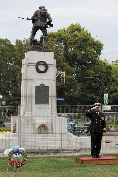 Reviewing Officer, Commander Jeff Watkins receives the General Salute in front of the Cenotaph at the B.C. Legislature.