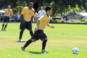 It’s a race to the ball between CFB Esquimalt and CFB Comox players. Photos by Rachel Lallouz, Lookout