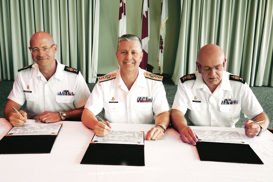 After two years at Maritime Forces Pacific, CPO1 Mike Feltham (right) has handed over his post to CPO1 Gilles Grégoire (left), with Rear-Admiral Art McDonald (centre) presiding over the event. Photo by Peter Mallett, Lookout
