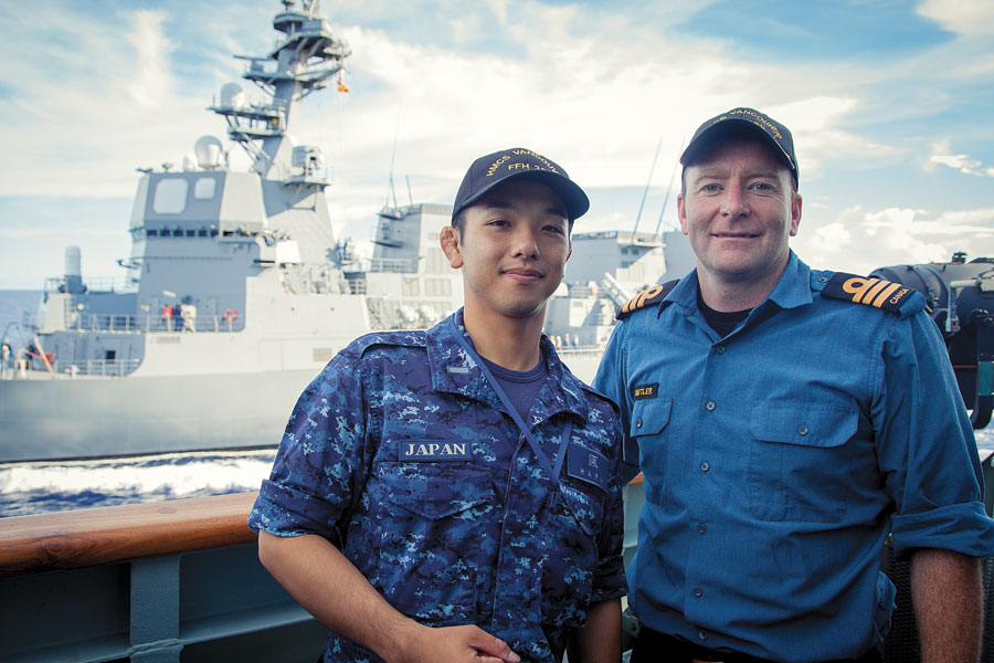 Ensign Yusuke Hara meets Commander Clive Butler during a CrossPol exercise while Vancouver transits in company of Japanese Maritime Self-Defense Force ship Fuyuzuki.