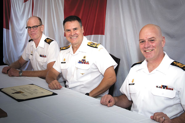 CPO1 Tom Riefesel, left, outgoing Command Chief Petty Officer; Vice-Admiral Ron Lloyd, centre, Commander RCN; and CPO1 Michel Vigneault, newly appointed Command Chief Petty Officer; sit together after signing the Change of Appointment certificate. Photo by Corporal (Cpl) Michael MacIsaac