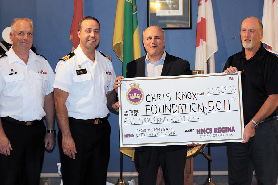 Left to right: Chief Petty Officer First Class Goulding and Commander Matthews present a cheque for $5,011.10 on behalf of HMCS Regina to the Chris Knox Foundation. Photos by Brent Fisher