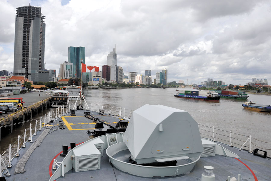 Commercial shipping traffic transits the Saigon River past HMCS Vancouver in Ho Chi Minh City, Vietnam, on Oct. 20.