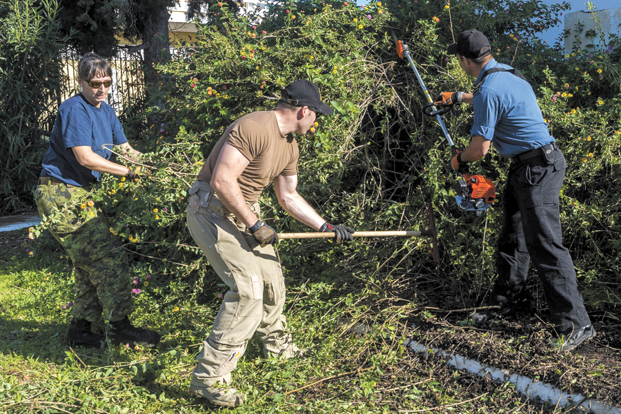 Crew members from HMCS Charlottetown spread some holiday cheer by helping to clean the grounds of an orphanage in Chania, Greece, during Operation Reassurance. Photos by Cpl Blaine Sewell, Formation Imagery Services