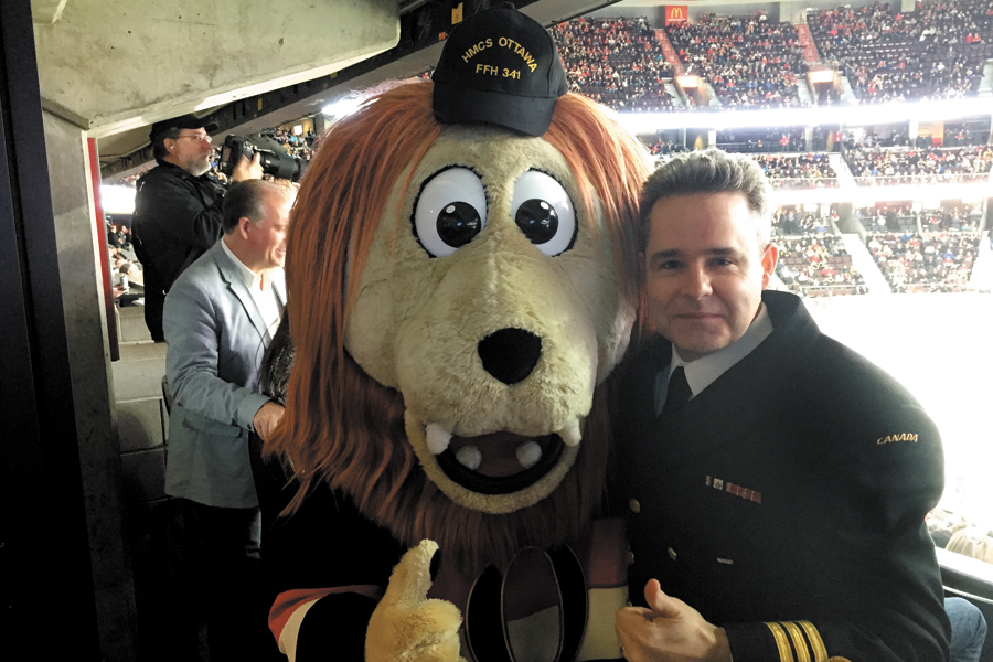 Commander Sylvain Belair with Ottawa Senators mascot Spartacat.