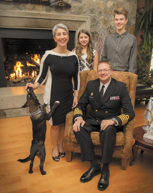 Base Commander, Captain (Navy) Steve Waddell with his family, wife Shuana, and children Nate and Bekah, plus the family dog Relic, in the Wardroom lounge. Cpl Carbe Orellana, MARPAC Imaging Services
