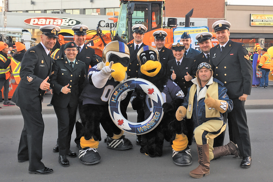 Winnipeg sailors in the Santa Claus parade with the Winnipeg Blue Bombers’ mascots.