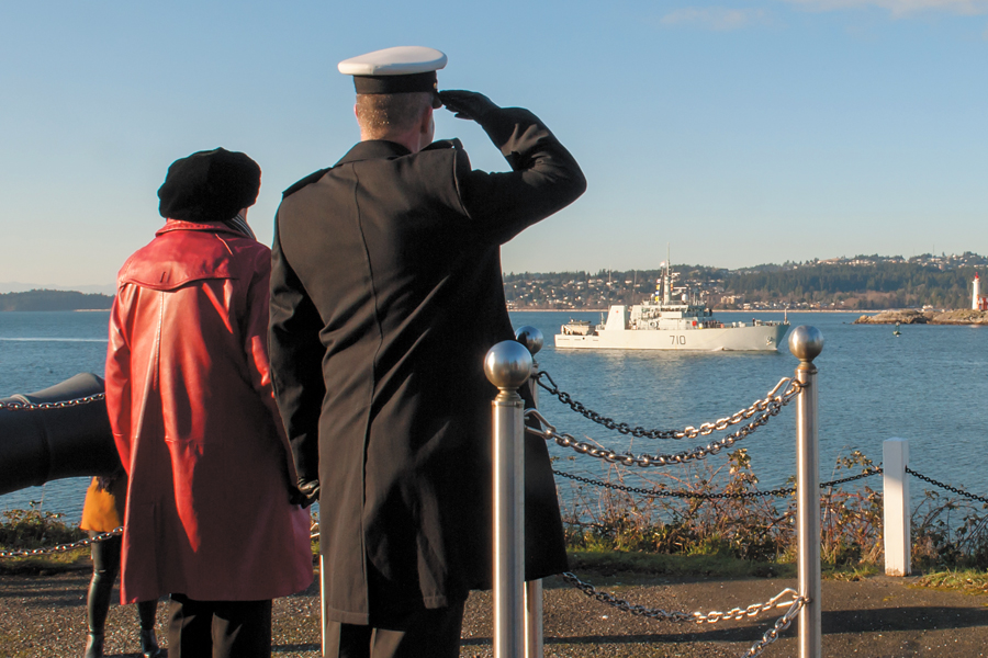 Rear-Admiral Art McDonald salutes Brandon as the ship sails by to come alongside in HMC Dockyard. Photo by LS Gariepy, MARPAC Imaging Services