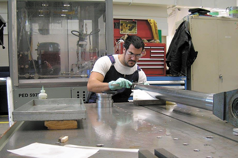 Apprentice Millwright Mark Gauvin works on a project in the Hydraulics Shop in Dockyard. The 27-year-old says he owes much of his success to his job placement at Dockyard’s Fleet Maintenance Facility which he says has greatly enhanced his skill set. Photo credit FMF