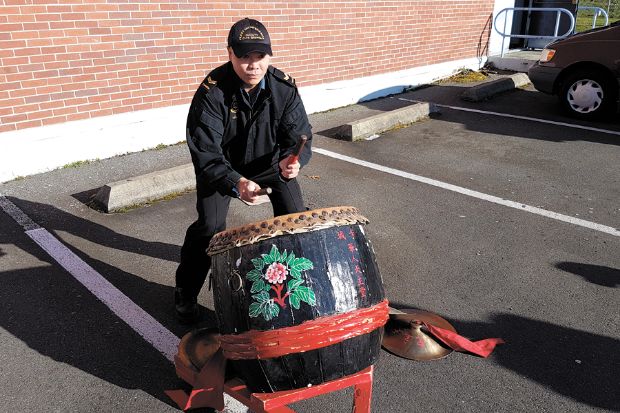 LS Dinh Tran tries the ceremonial drum used in the Lion Dance Ceremony. Photo by LS Jordan Moore, FMF