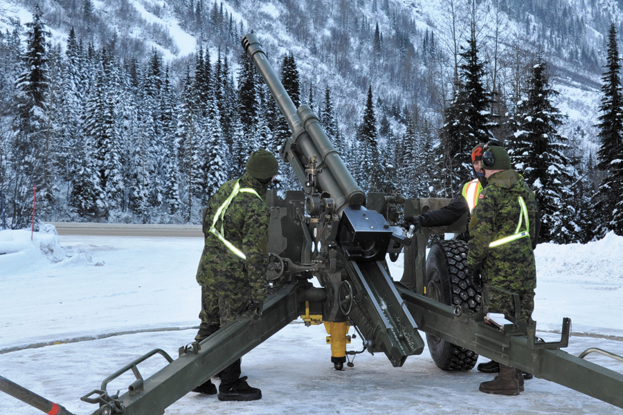 Members of 1st Regiment Royal Canadian Horse Artillery instruct Parks Canada Agency staff on how to position the site on the C3 Howitzer gun. Photo by SLt Melissa Kia, Public Affairs Officer, MARPAC