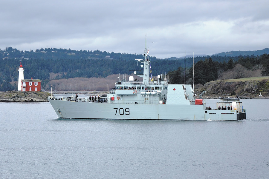 HMCS Saskatoon leaves Esquimalt Harbour, passing Fisgard Lighthouse for Operation Caribbe, Canada’s contribution to combat the international drug trade. Photo by SLt Melissa Kia, MARPAC Public Affairs