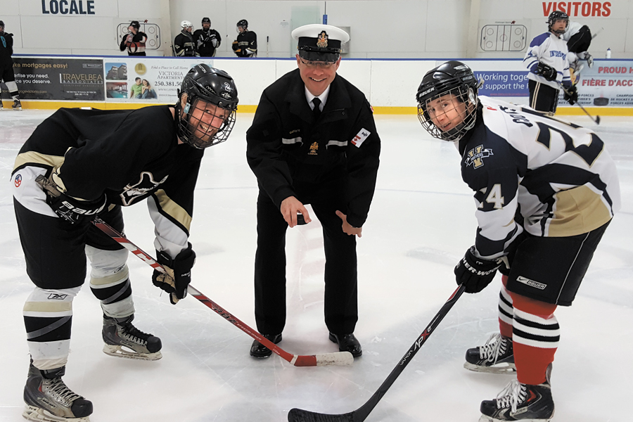 Formation Chief CPO1 Gilles Gregoire (centre) is set to drop the puck in the ceremonial opening faceoff of the first annual Weapons Engineering Trade Hockey Challenge at Wurtele Arena, Feb. 10. The game brought members of the trade together on the ice for an afternoon of esprit de corps. Photo by CPO2 Maxime Michel