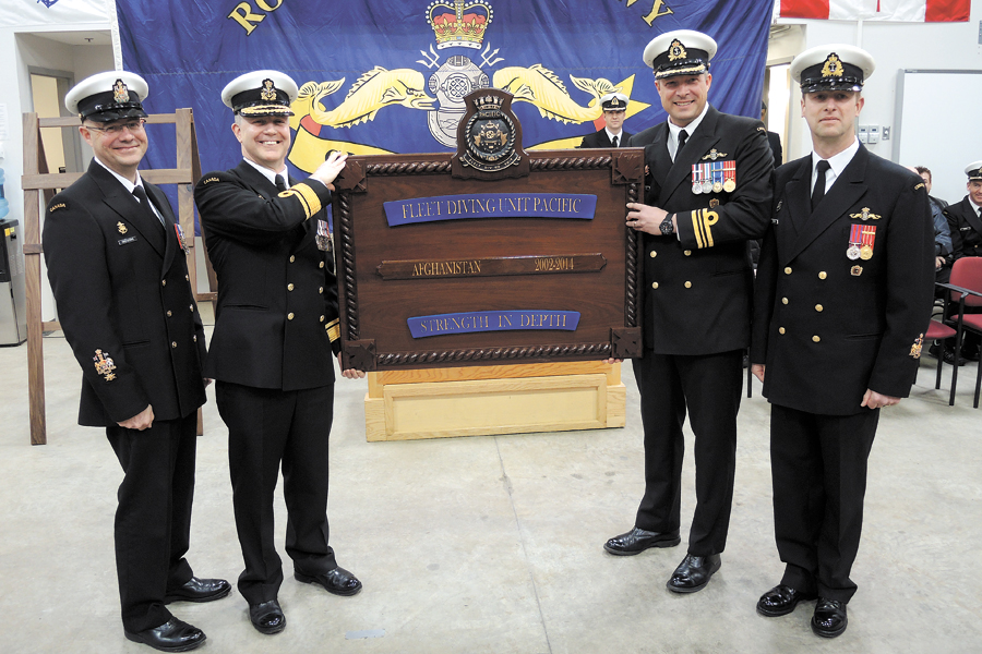 From the left: RAdm Art McDonald, Commander of Martime Forces Pacific; CPO1 Gilles Gregoire, Formation Chief; LCdr Chad Naefken, Commanding Officer Fleet Diving Unit (Pacific); and CPO1 Robert DeProy, FDU Coxswain, display the Battle Board presented at the unit’s Theatre Honours ceremony Feb. 28. The unit’s Clearance Divers were recognized for their bomb-defusing efforts in Afghanistan. Photos by Peter Mallett, Lookout Newspaper