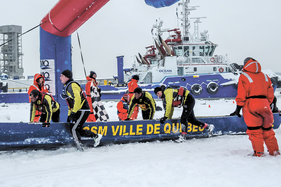 Members of the HMCS Ville de Québec ice canoe-racing team approach the finish line at the Québec Carnival Ice Canoe Race on Feb. 5. Photo by Cpl Eric Girard, Combat Camera