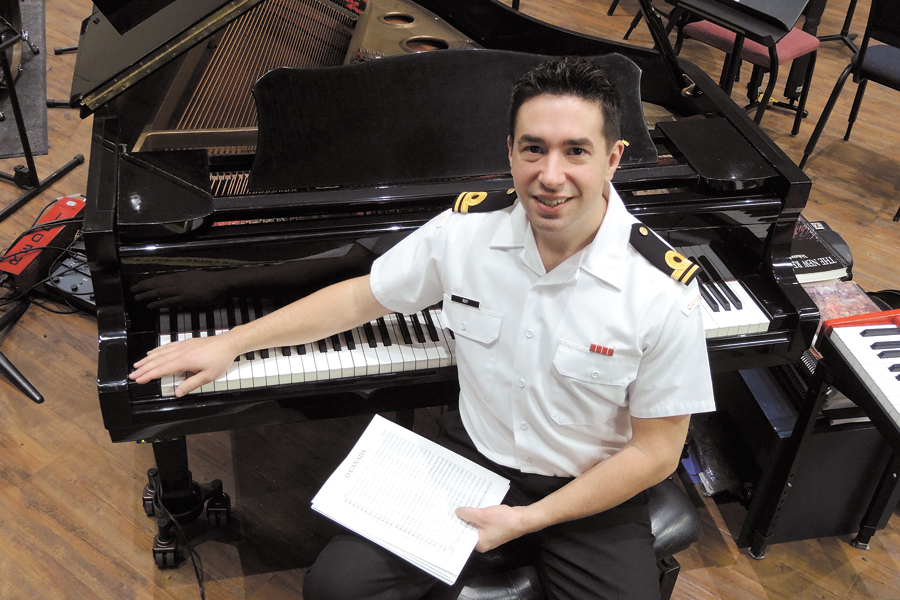 SLt Vincent Roy, Musical Director of the Naden Band, takes a break while practicing a new arrangement of the national anthem he created for the Music Branch of the Canadian Armed Forces. SLt Roy began working on his one-size-fits-all ensemble in 2012. It is now the official arrangement used by military bands across the country. Photo by Peter Mallett, Lookout Newspaper