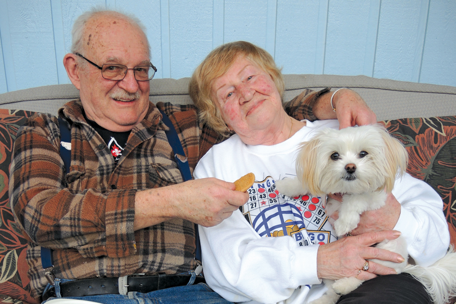 CPO2 (Ret’d) Neil Laur, his wife Maggie, and their dog Daisy take a break from their daily activities to enjoy some chocolate chip cookies on their back porch.