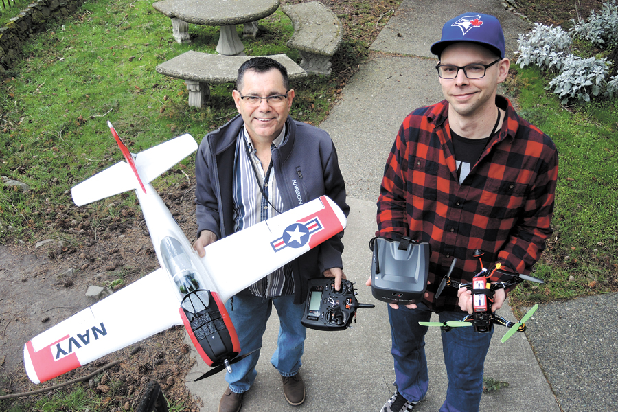 PO1 Corey Howe (left) and PO2 Aaron Murray, both support technicians who work at Fleet Maintenance Facility, display thier flying machines. The two co-workers are currently in the application process of forming a club for model airplane and quadcopter enthusiasts. The  proposed Pacific Model Aeronautics Club and its application is currently under review by Personnel Support Services staff.