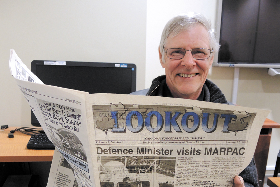 Lloyd Mathews, former FMF Weapons Shop worker, displays a Jan. 15, 1997, issue of the Lookout newspaper that he buried in a time capsule along with other items. Photo by Peter Mallett, Lookout Newspaper