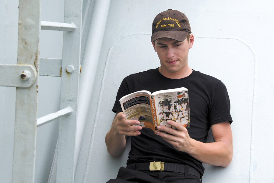 A boatswain onboard HMCS Saskatoon reads on the sweep deck during Operation Caribbe. Photo by Royal Canadian Navy Public Affairs