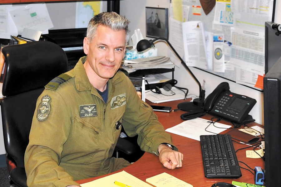 Major Justin Olsen, Officer in Charge of the Joint Rescue Coordination Centre Victoria, at his desk at CFB Esquimalt. 