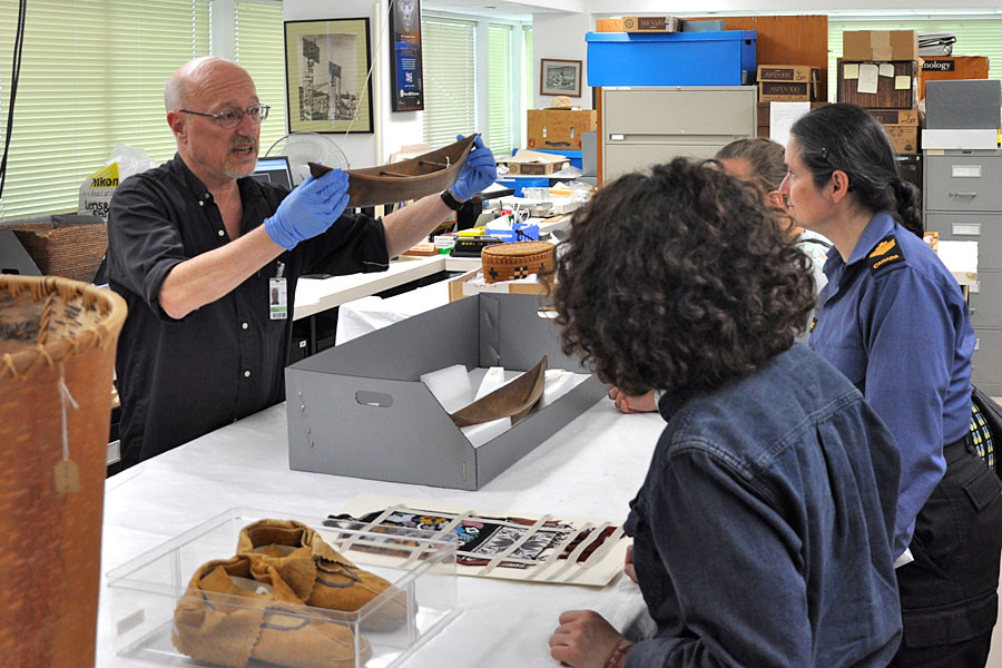 Brian Seymour, Collections Manager of the Department of Anthropology of the Royal BC Museum, show artifacts to CFB Esquimalt members during a special collections tour. Photo by William Chaster, MARPAC PA Office