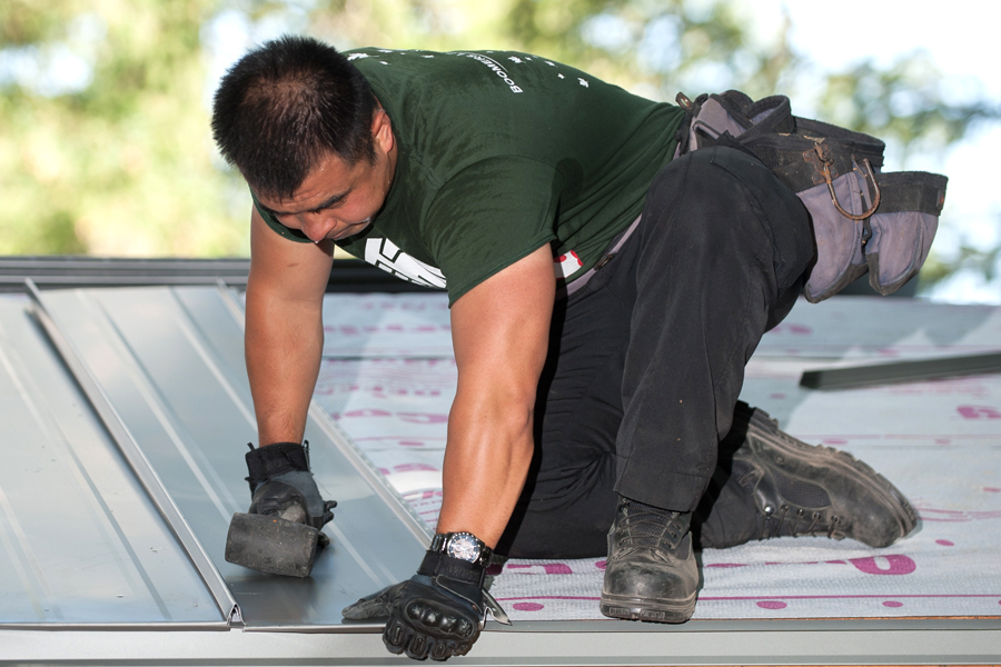 A member of the Canadian Armed Forces installs a new roof during a HeroWork Radical Renovation at the site of the former Prospect Lake Golf Club. Military and civilian volunteers built a campsite for Victoria-based non-profit Power To Be. Photo by JW Penner, John’s Photography