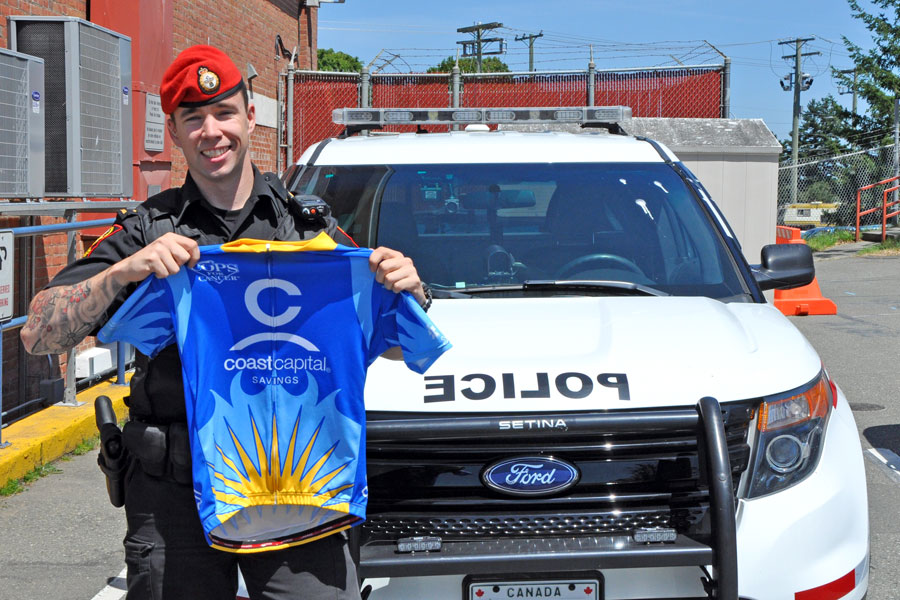 Corporal Matthew Best, Military Police Unit Esquimalt poses with a Tour de Rock jersey. 