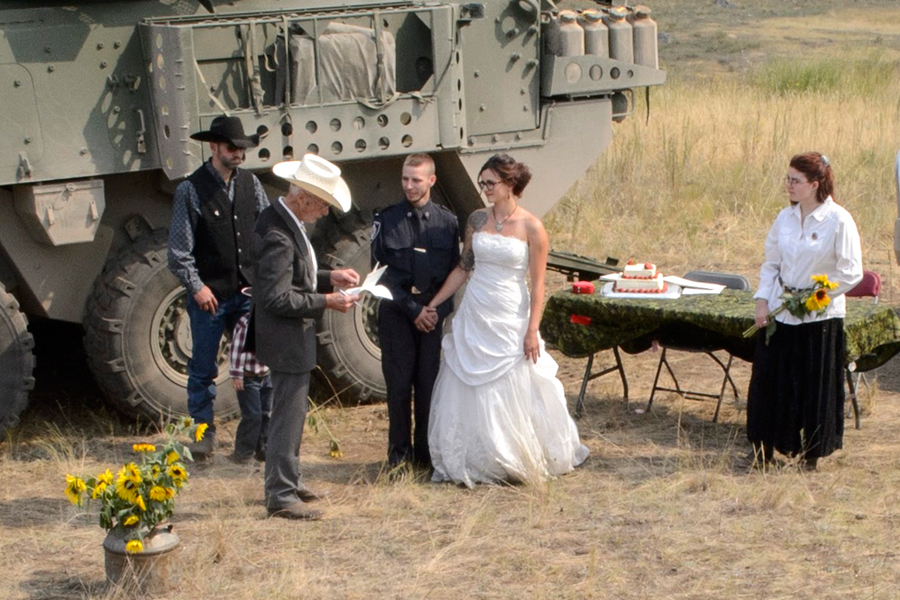 Lara Agapow (center right) and Tristan Vanderklok (center left), workers from B.C. Wildfire Services, are married at Camp Riske Creek, B.C., on Aug. 19 during Operation Lentus. Photos by Cpl Blaine Sewell, MARPAC Imaging Services